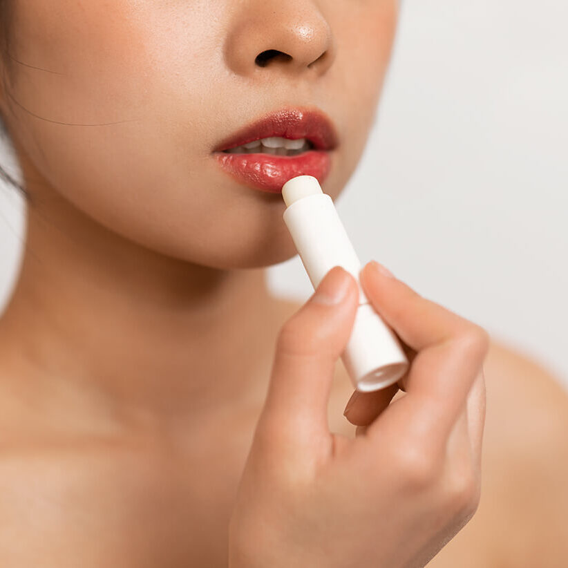 cropped-korean-lady-using-lipbalm-taking-care-her-beautiful-lips-putting-hygienic-lipstick