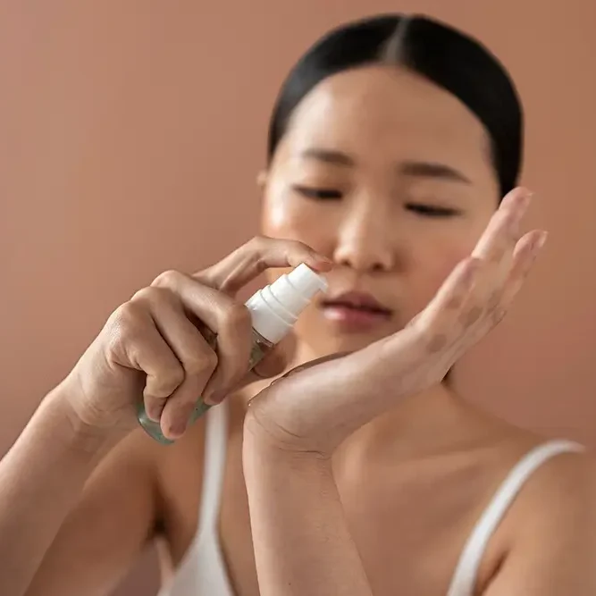 medium-shot-korean-woman-posing-with-serum copy (1)