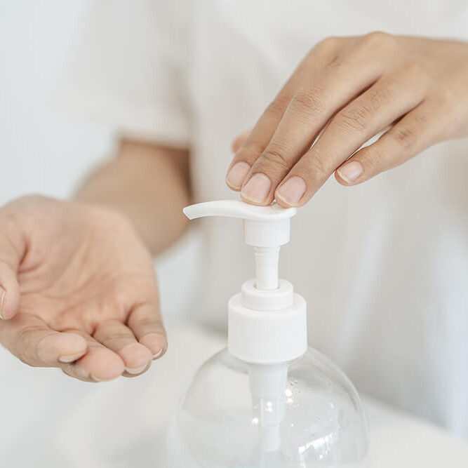 women-wearing-white-shirts-that-press-gel-wash-hands-clean-hands