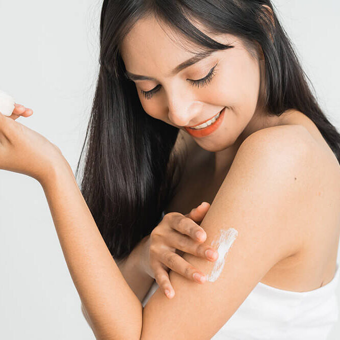 young-skin-care-asian-woman-applying-body-lotion-arm-shoulder